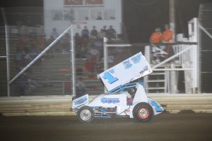 #1w Paul Weaver takes the checker flag for the 305 sprint feature win Friday at Attica Raceway Park. - Action Photo