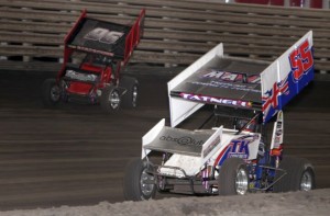 Bronson Maeschen (96) takes the high side around Brooke Tatnell (55) during the 410 feature at Knoxville Raceway in Knoxville, Iowa on 27 April 2013. - Serena Dalhamer