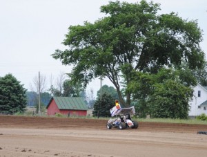 Chad Kemenah passes the pig farm located outside turn three at I-96 Speedway. - T.J. Buffenbarger Photo