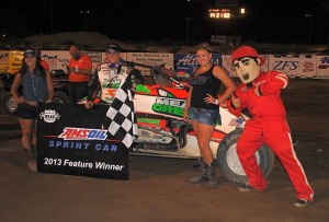 Brady Bacon with the trophy queens and Dusty Dan in victory lane at I-96 Speedway. - T.J. Buffenbarger Photo