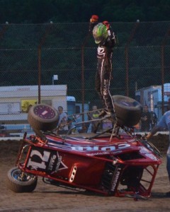 Kyle Larson salutes the crowd after turning his car over doing celebratory doughnuts following his opening night feature win during the 2013 edition of Indiana Midget Week. - Bill Miller Photo
