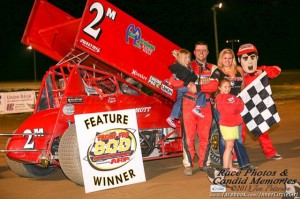 Dustin Daggett with his daughters, trophy girl, and Dusty Dan in victory lane Saturday at I-96 Speedway. - Jennifer Peterson Photo