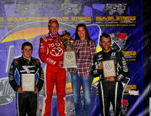 After winning Thursday night's USAC National Midget feature win at Canyon Speedway Park's 46th Annual Western World Championships, Christopher Bell is joined on the podium by runner-up Brady Bacon (left) and Bryan Clauson (right).  (Patrick Shaw photo)