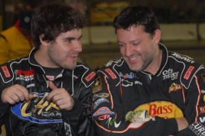   Three-time NASCAR champion Tony Stewart (right) shares a moment with fellow driver Cap Henry at last year’s “Rumble in Fort Wayne.” Despite a broken leg that continues to keep him out of a race car, Stewart will return as a car owner for the 16th annual indoor midget races on Friday, Dec. 27 and Saturday, Dec. 28 at the Memorial Coliseum Expo Center. He’ll also greet fans and sign autographs both days. / Photo by Jim Morrison/Hawkeye Racing News