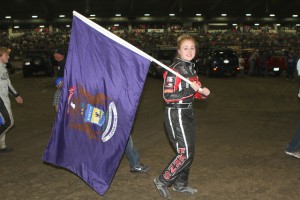 Taylor Ferns carries the Michigan Flag in the parade of states at the 2014 Chili Bowl Nationals. - James McDonald / Apex One Photo