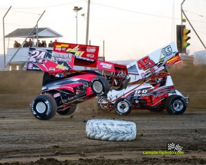 Brandon Wimmer airborn just before turning over Saturday night at Attica Raceway Park. - Mike Campbell Photo