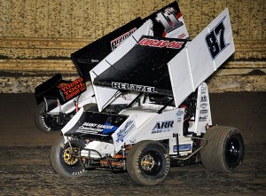 Aaron Reutzel (87) races with Mike Goodman en route to an eventual win in Friday night's event at Creek County Speedway in Sapulpa, OK. (The Wheatley Collection)