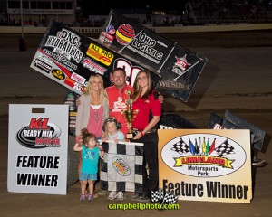 Greg Wilson with wife Mackenzie, daughters Alivia and Lilli celebrate winning the NRA Sprint Invader featureat Limaland Motorsports Park. Mike Campbell Photo www.campbellphoto.com