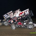 Randy Hannagan (#11n), Brandon Wimmer (#24H), and Dale Blaney (#14K) racing three wide for position at Attica Raceway Park. - Mike Campbell Photo