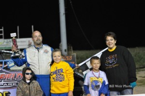 Mike Miller with his family in victory lane on Saturday night at Waynesfield Raceway Park. - Bill Weir Photo