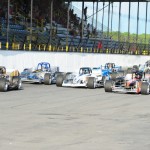  A pack of Novelis Supermodifieds fly down the front stretch at the 'Steel Palace' during qualifying for the 2014 Jim Shampine Memorial 75. (Bill Taylor Photo)