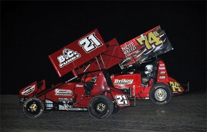 Tyler Thomas (21) and John Carney II (74b) battle for the lead in the closing laps of Friday's 305 Sprint Car Shootout preliminary feature at Southern New Mexico Speedway. (TWC Photo)