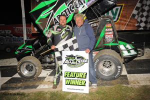 Kraig Kinser standing in Bubba Raceway Park victory lane with his father Steve Kinser on Friday, February 5. (Paul Arch Photo)