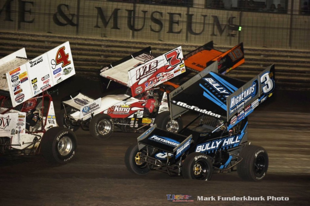 Ian Madsen (#18), Jason Sides (#7S), and James McFadden (#3) racing for position around Danny Smith (#4) Friday during the SPEED SPORT World Challenge at Knoxville Raceway. (Mark Funderburk Photo)