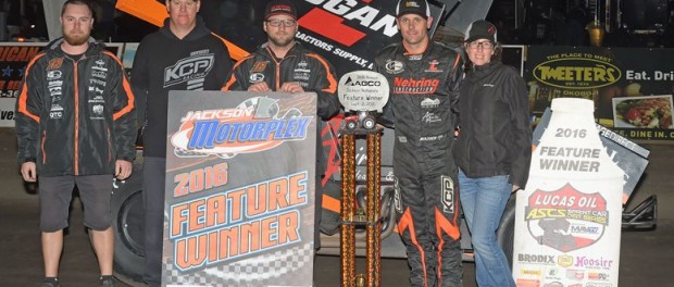 Ian Madsen with his team in victory lane following their victory Friday at Jackson Motorplex. (ASCS / Rob Kocak Photo)