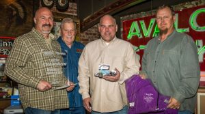 Robert Sellers (far left) receives his trophy while John Stewart (center) presents Sellers with a replica of the championship car. David Moss (car owner) is on the right while Ameri-Flex / OCRS president Barry Grabel looks on. (Kent Bergman Photo) 