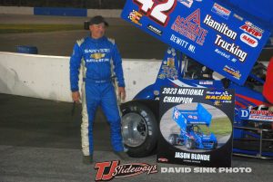  Jason Blonde poses with the Must See Racing championship banner after claiming his first series title over Charlie Schultz. (David Sink photo)