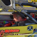 Mike McVetta strapping in the car before the feature event. (T.J. Buffenbarger photo)