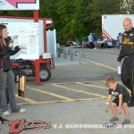 Bobby Santos III's son chooses a frisbee for him during the redraw for the feature event Friday at Kalamazoo Speedway. (T.J. Buffenbarger Photo)