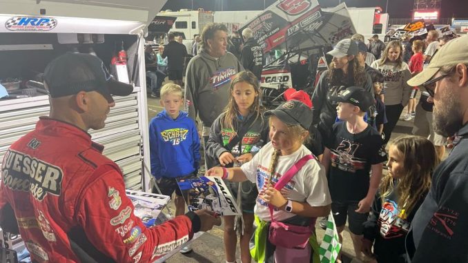 Bill Balog signing autographs after his fifth place run Thursday at Knoxville Raceway. (T.J. Buffenbarger Photo)