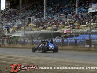 Justin Grant takes the checkered flag at the Illinois State Fairgrounds. (Mark Funderburk Photo)