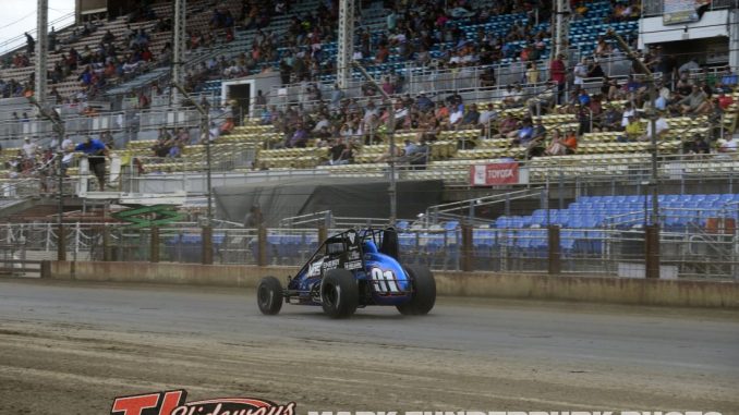 Justin Grant takes the checkered flag at the Illinois State Fairgrounds. (Mark Funderburk Photo)