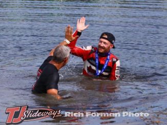 Driver C.J. Leary and team owner Mike Burkhart took the plunge into the infield lake after winning Saturday's Ted Horn 100 USAC Silver Crown race at the Du Quoin State Fairgrounds in southern Illinois. (Rich Forman Photo)