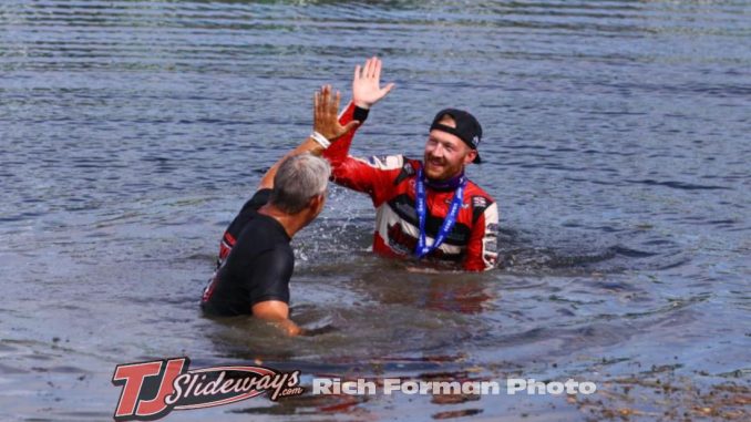 Driver C.J. Leary and team owner Mike Burkhart took the plunge into the infield lake after winning Saturday's Ted Horn 100 USAC Silver Crown race at the Du Quoin State Fairgrounds in southern Illinois. (Rich Forman Photo) Driver C.J. Leary and team owner Mike Burkhart took the plunge into the infield lake after winning Saturday's Ted Horn 100 USAC Silver Crown race at the Du Quoin State Fairgrounds in southern Illinois. (Rich Forman Photo)