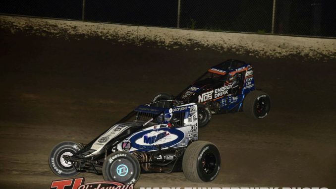Logan Seavey (#57) racing with Justin Grant (#4) Friday at Tri-City Speedway. (Mark Funderburk Photo)