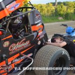 Travis Arenz and his team make final adjustments before going out for their heat race Friday at I-96 Speedway. (T.J. Buffenbarger Photo)