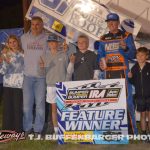Clinton Boyles in victory lane with car owner Shannon Eifert and family after winning Friday night at I-96 Speedway. (T.J. Buffenbarger Photo)
