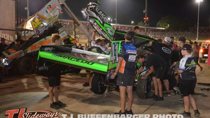 Carson Macedo's entry being reassembled by multiple teams in work area Friday night at Eldora Speedway. (T.J. Buffenbarger Photo)