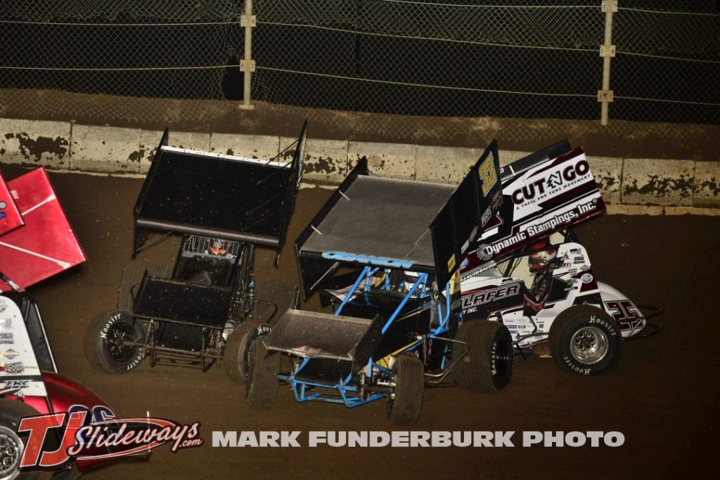 Shane O'Banion (#33) sideways with Danny Schlafer (#25) and another competitor Friday during the Interstate Racing Association event at Jacksonville Speedway. (Mark Funderburk Photo)