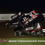 Riley Goodno (#22), Cameron Martin (#4), and Cole Schroeder (#3) racing for position Monday night at Marshalltown Speedway. (Mark Funderburk Photo)
