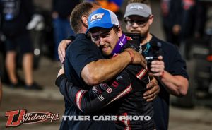 Emerson Axsom and his father embrace after winning the feature event Sunday night with the World of Outlaws at Huset's Speedway. (Tyler Carr Photo)