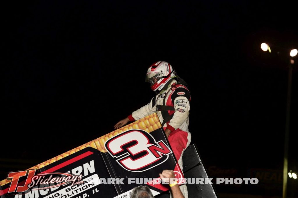 Jake Neuman climbs to the top of the car celebrating his feature victory Friday night at Jacksonville Speedway. (Mark Funderburk Photo)