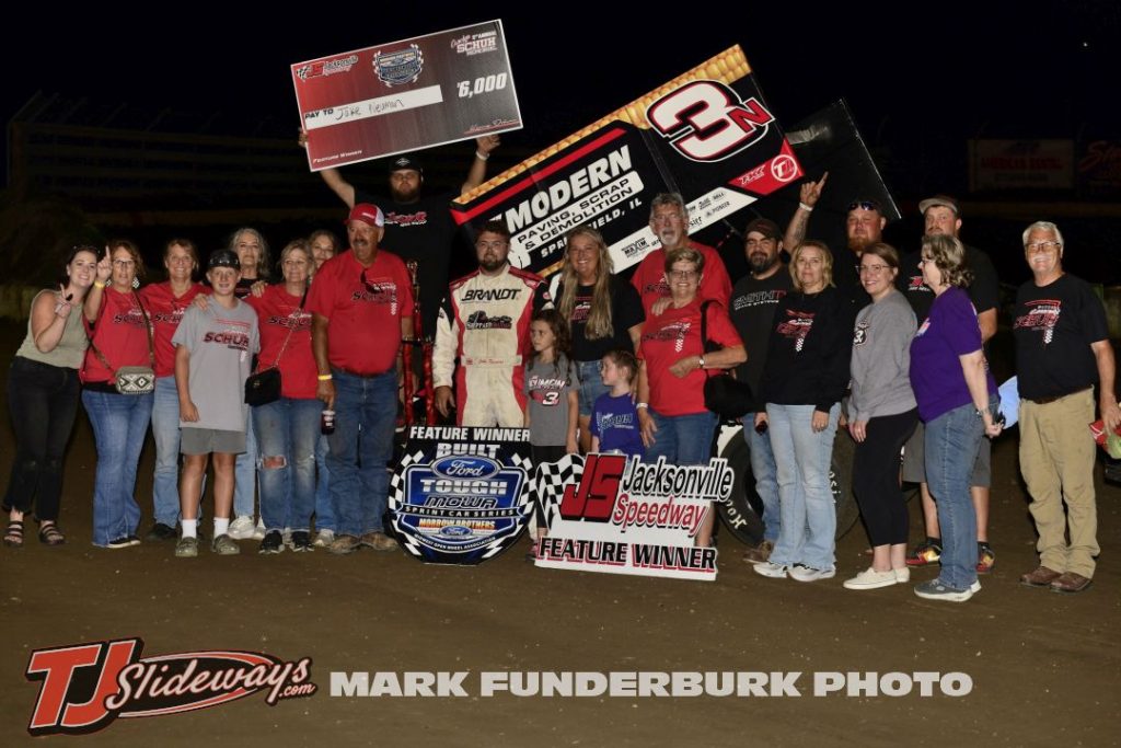 Jake Neuman with his family and crew after winning the feature victory Friday night at Jacksonville Speedway. (Mark Funderburk Photo)